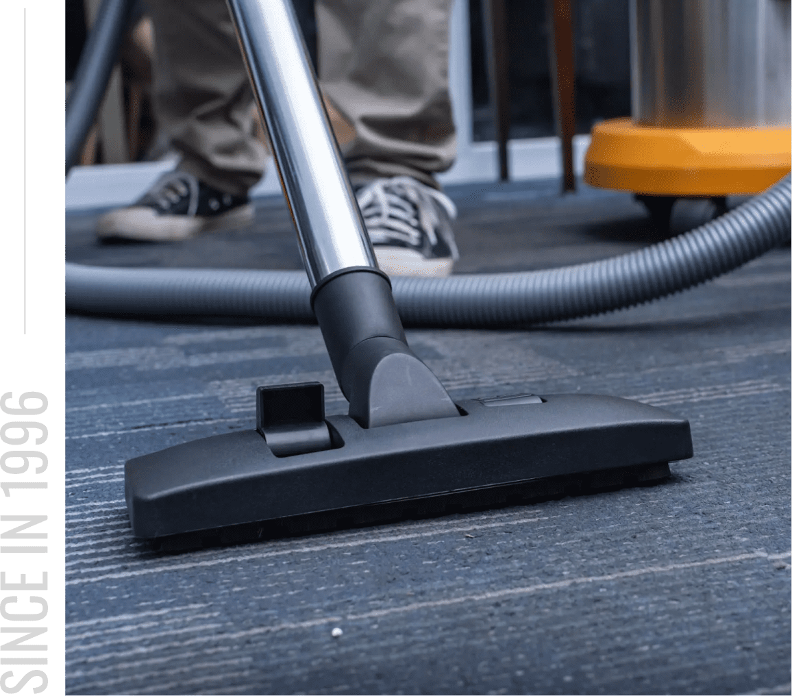 Person vacuuming office carpet