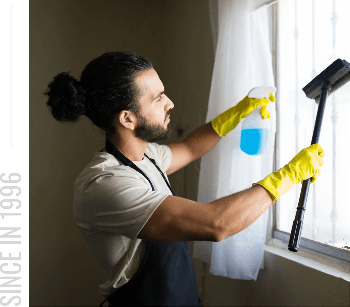 Person using spray bottle on window
