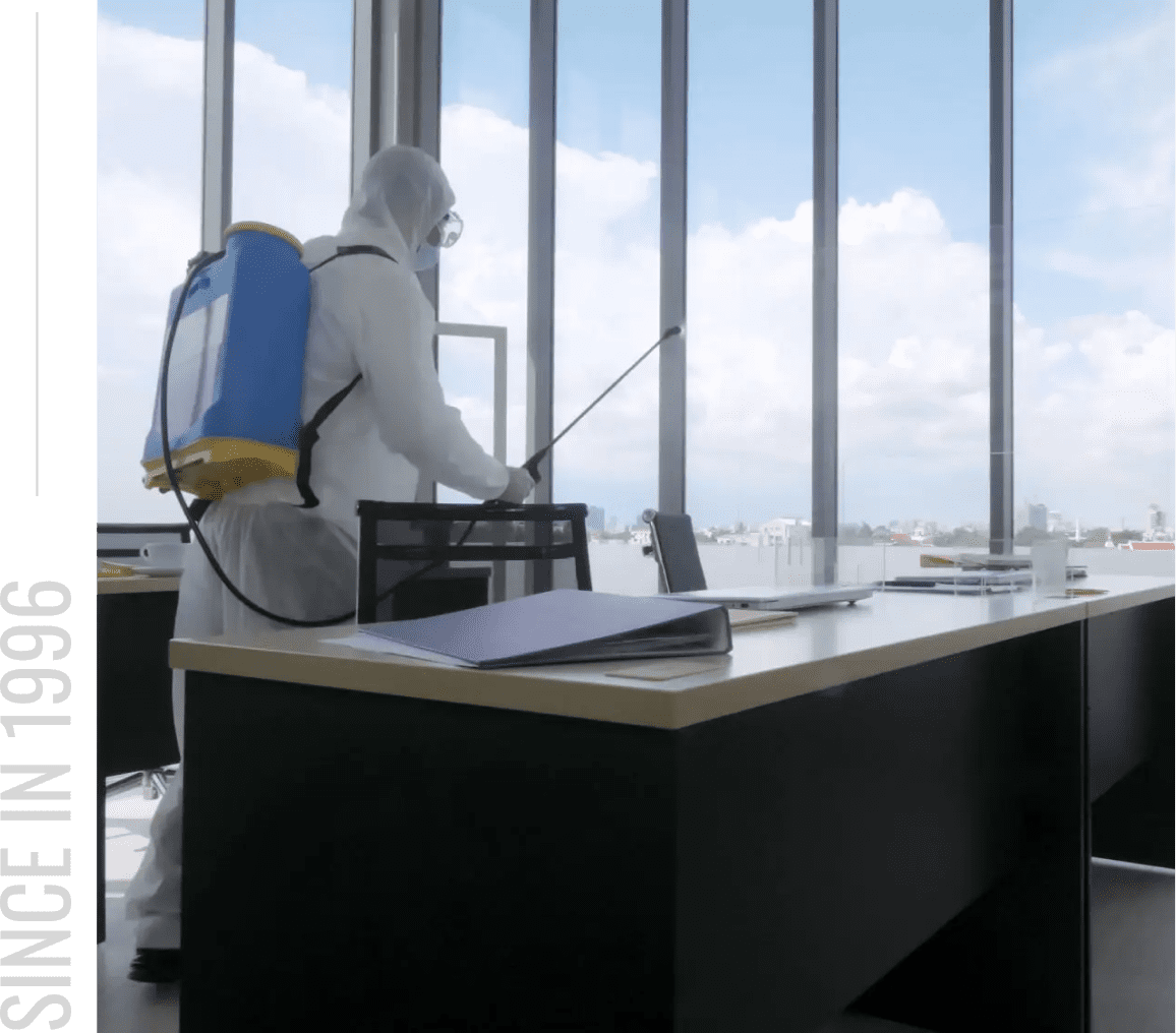 Sanitizing desk with protective gear.