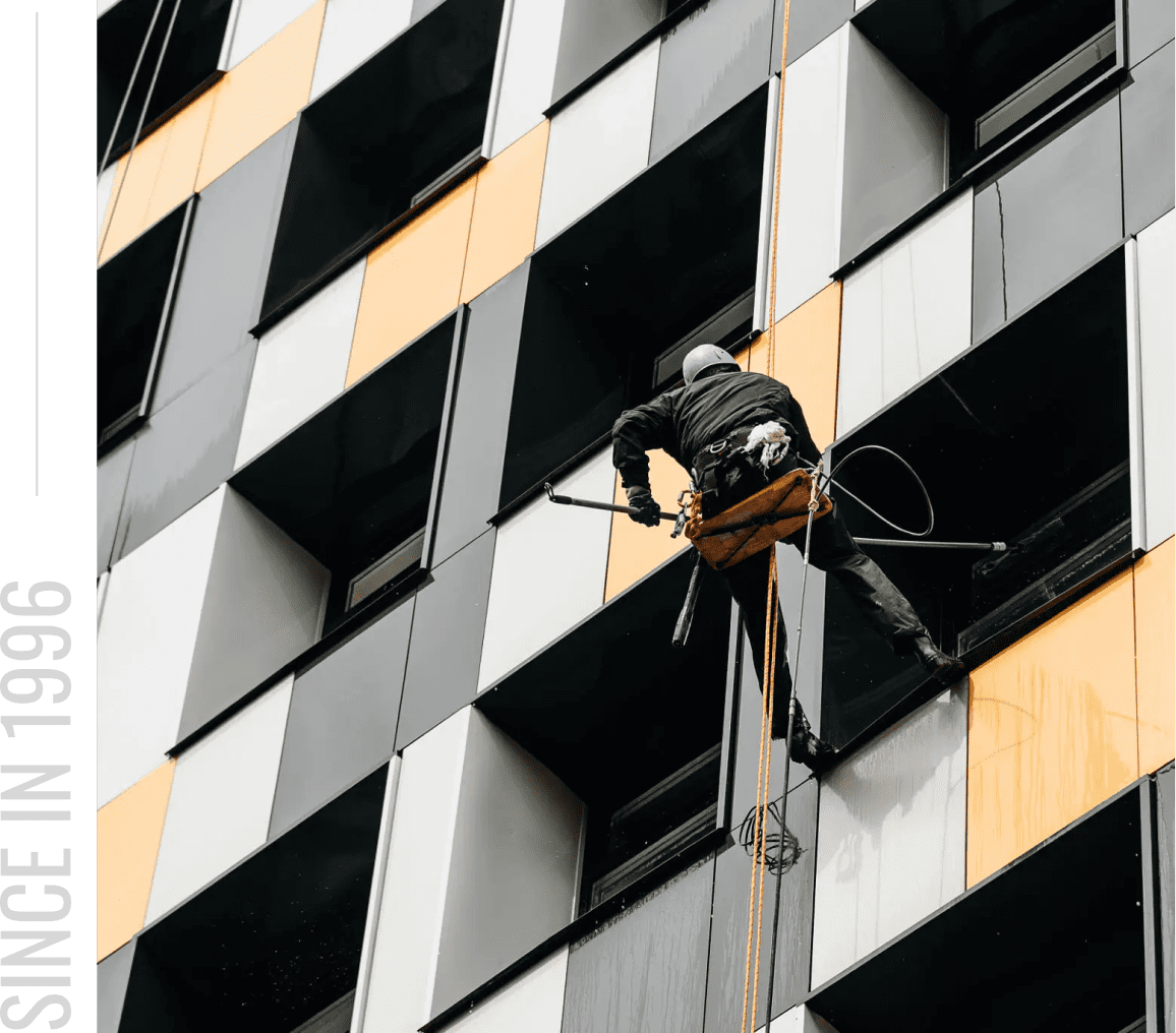 Worker cleaning tall building windows