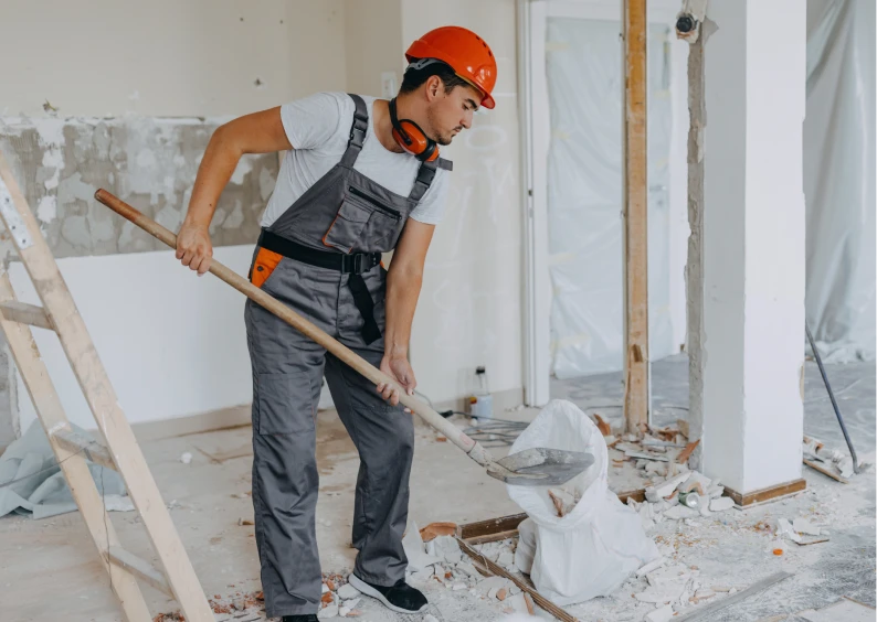 Man in hard hat renovating interior