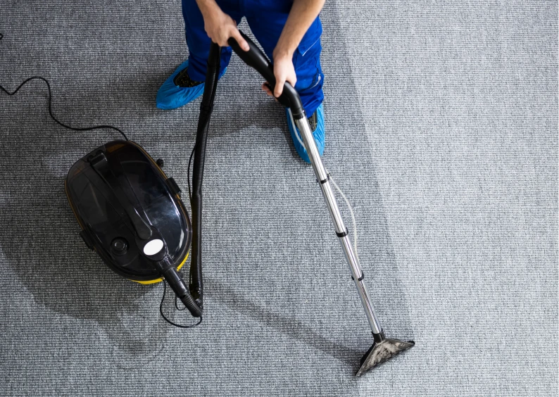 Carpet cleaning in progress with vacuum